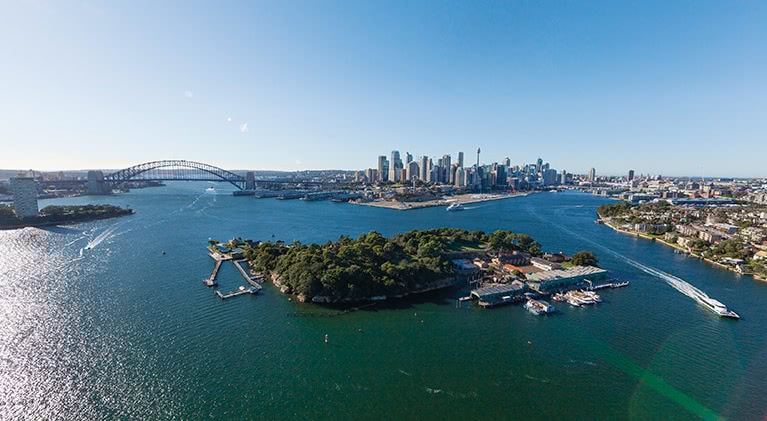 Sydney Harbour, Sydney Harbour Bridge and Sydney's city skyline, with Goat Island in the foreground