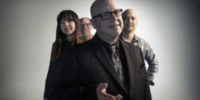 Studio shot of the Pixies members, Black Francis in the centre, David Lovering, Joey Santiago and new bassist Paz Lenchatin