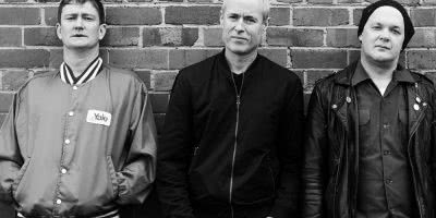 Sydney rock band The Peep Tempel, standing against a brick wall.