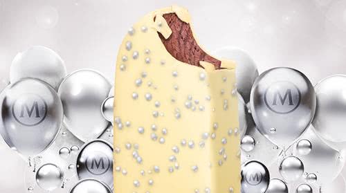 White chocolate and silver balls covering a Red Velvet Magnum on a background of silver Magnum balloons