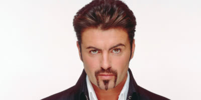 Pop music icon, George Michael with a goatee, white shirt and black jacket