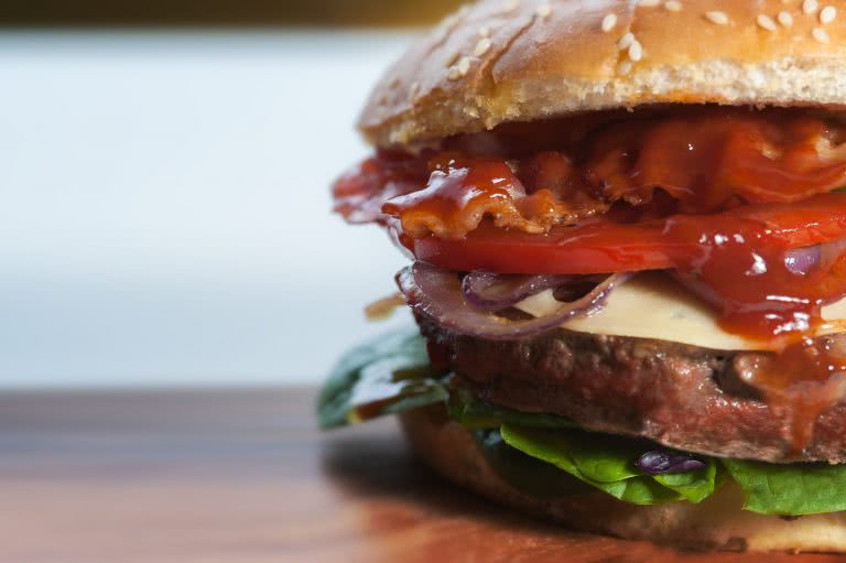 Hamburger with bacon, swiss cheese, lettuce, tomato, meat patty, sesame seed bun at Burgapalooza