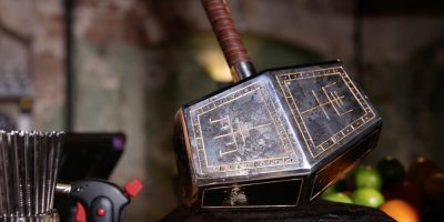 Thor's hammer, engraved with Scandinavian symbols, sits on a bar