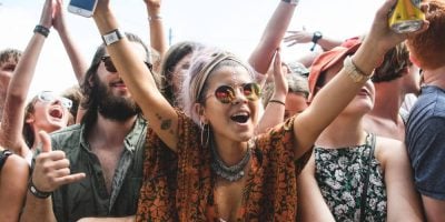 A young female music festival-goer enjoys the music