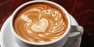 A flat white with a heart in the foam