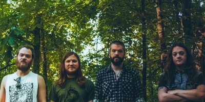Little Rock doom metal giants Pallbearer, standing in the midst of a forest.