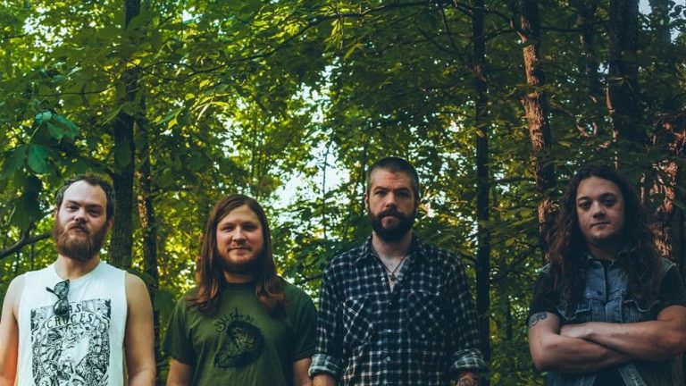 Little Rock doom metal giants Pallbearer, standing in the midst of a forest.