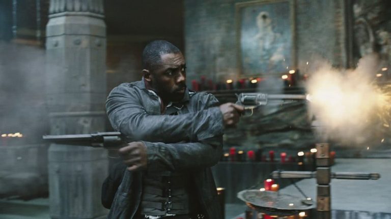 Idris Elba as The Gunslinger, firing two crossed pistols in The Dark Tower