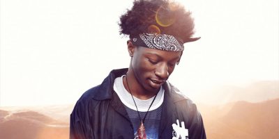 Joey Bada$$ pictured responsibly staring away from the sun.