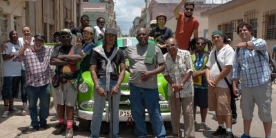 The members of Havana Meets Kingston in front of a car