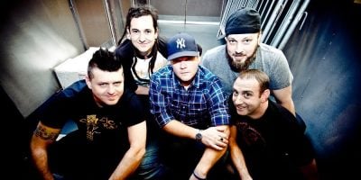 Less Than Jake sitting on some stairs