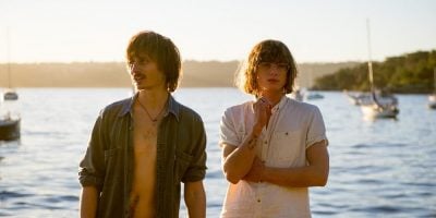 The two members of Lime Cordiale standing in front of the ocean