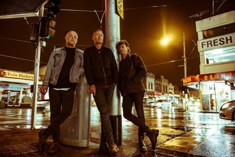 The members of The Peep Tempel standing on a street corner