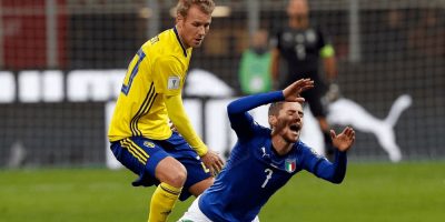 An Italian soccer player falls in a tackle