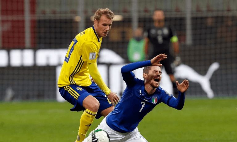 An Italian soccer player falls in a tackle