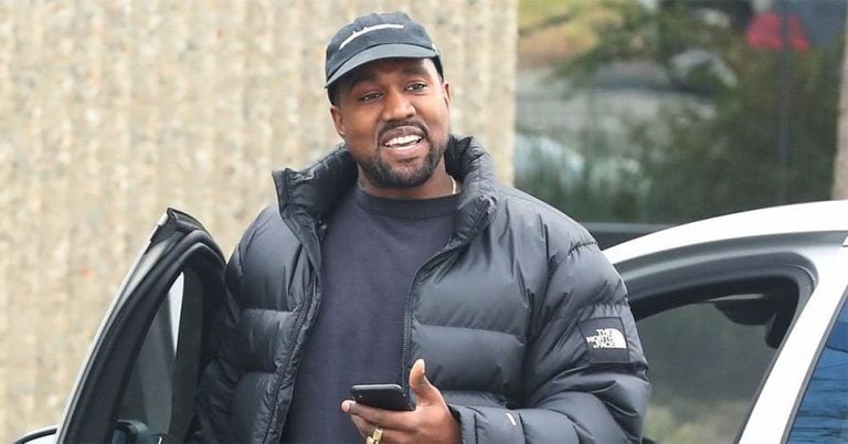 An image of Kanye West sporting a rare smile