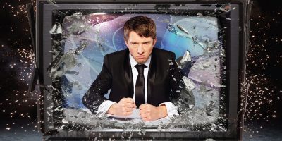 Newsreader Jonathan Pie smashes through a television