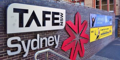 tafe nsw building sign in sydney on brick wall