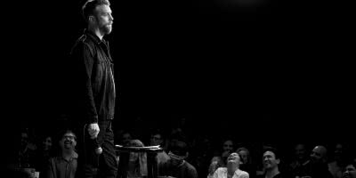 Anthony Jeselnik black and white onstage