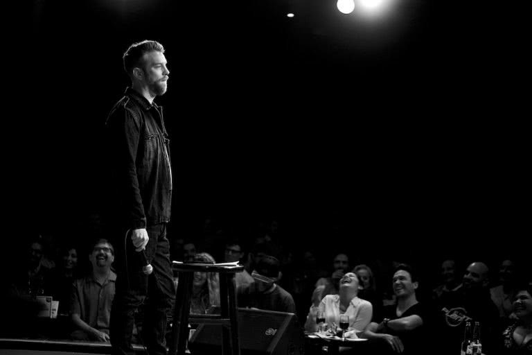 Anthony Jeselnik black and white onstage