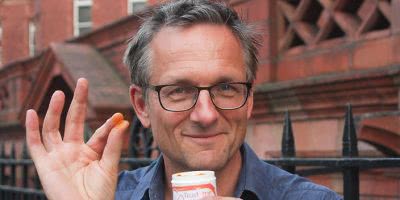 Dr Michael Mosley holding orange powder