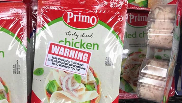 Image of stickers placed on Woolworths chicken by vegan activists