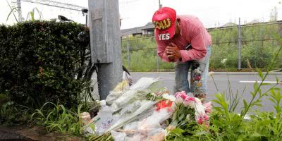 Flowers placed for 33 killed in Kyoto fire