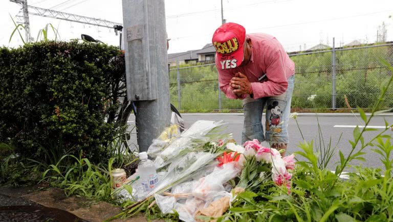 Flowers placed for 33 killed in Kyoto fire