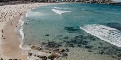 View of Sydney's Bondi Beach chock-full of people.