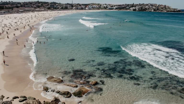 View of Sydney's Bondi Beach chock-full of people.