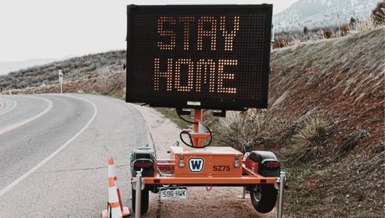 Road sign telling people to stay home in the midst of COVID-19