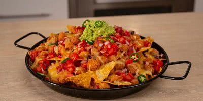 KFC popcorn chicken nachos in a skillet