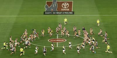 AFL players kneel for Black Lives Matter