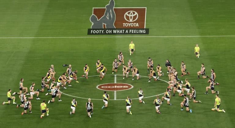 AFL players kneel for Black Lives Matter