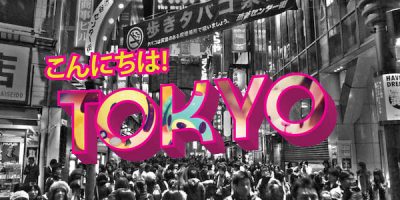 Black and white photo of people walking in a street with pink Japanese writing and Tokyo in pink block letters