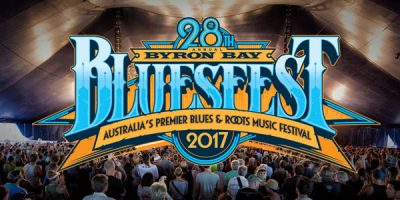 Crowed under stand with Bluesfest font over photo