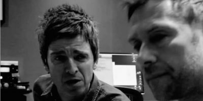 Black and white image Noel Gallagher and Damon Albarn close up to camera