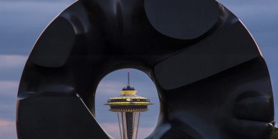 Seattle's landmark Space Needle poking through hole of object in front of camera