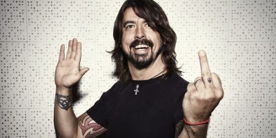 Dave Grohl smiling and giving the finger