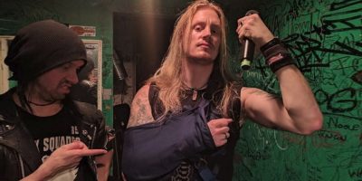 Dragonforce frontman Marc hudson in a sling