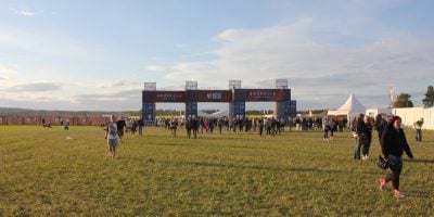 An empty field and festival gate