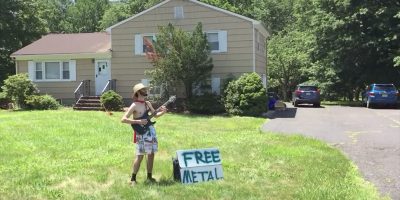 Screenshot of a YouTube video showing a caped musician playing guitar