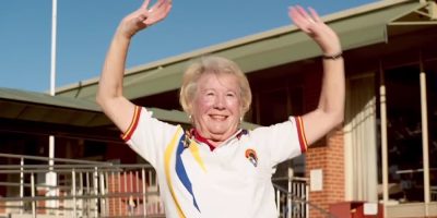 An elderly lawn bowler celebrating