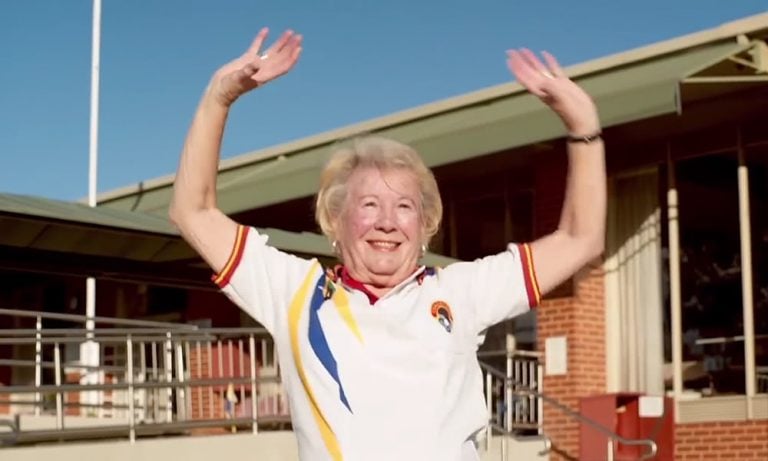 An elderly lawn bowler celebrating