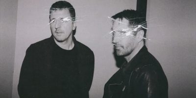 Atticus Ross and Trent Reznor of Nine Inch Nails, with digital scratching effects over their faces