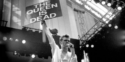 The Smiths' Morrissey holding a sign while performing live