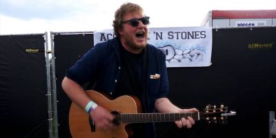 The Smith Street Band frontman Wil Wagner playing an acoustic guitar