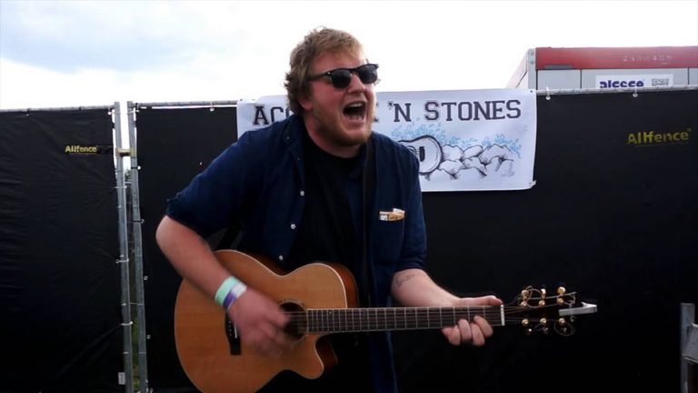 The Smith Street Band frontman Wil Wagner playing an acoustic guitar