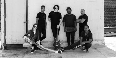 Jack White posing with other musicians while recording his new record