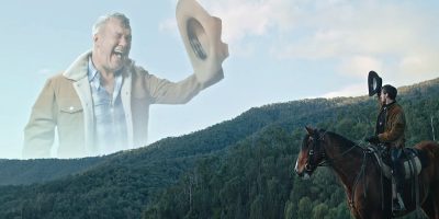 Jimmy Barnes appears as a cowboy floating in the sky